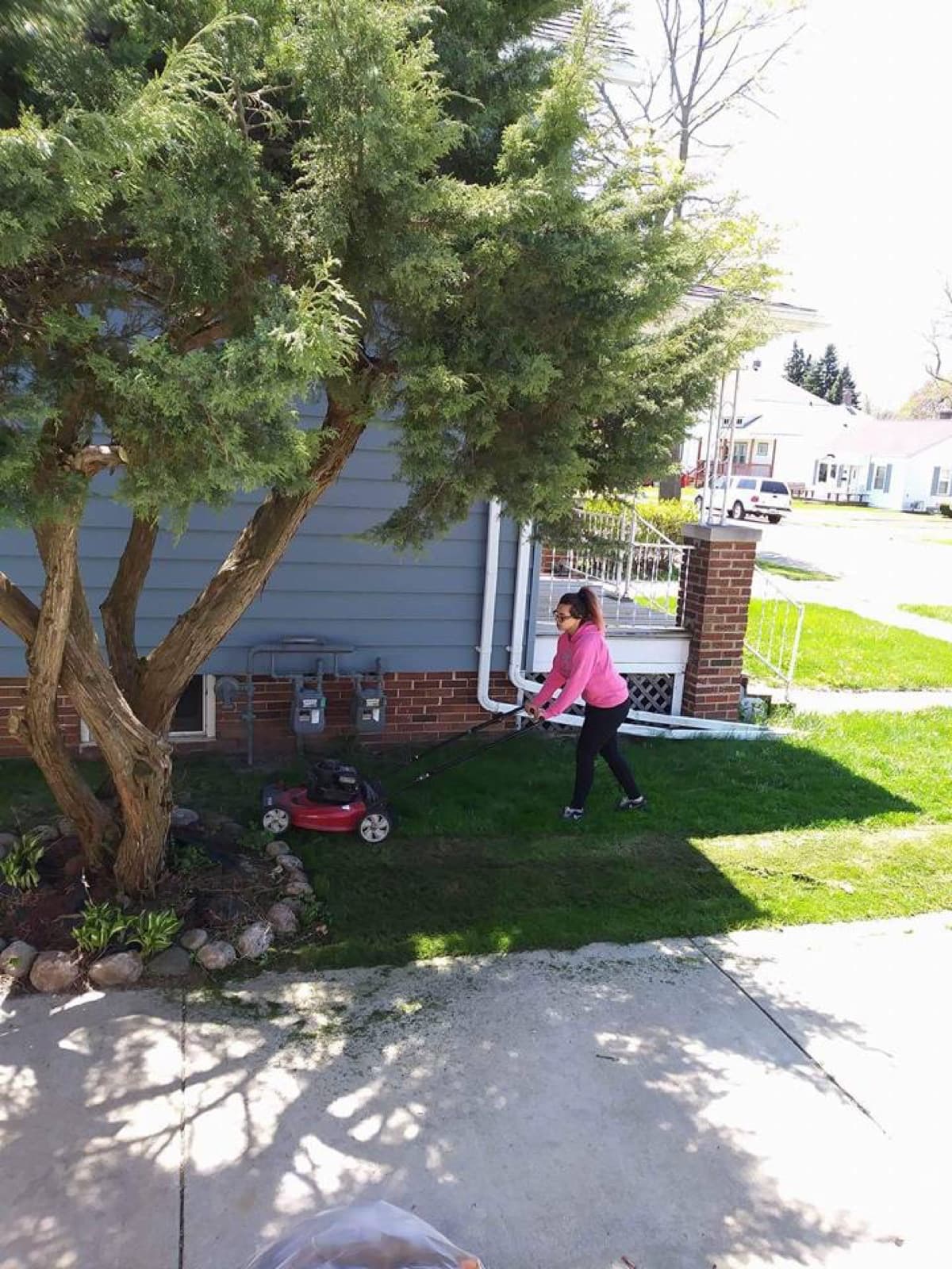 Youth mowing a lawn in Racine