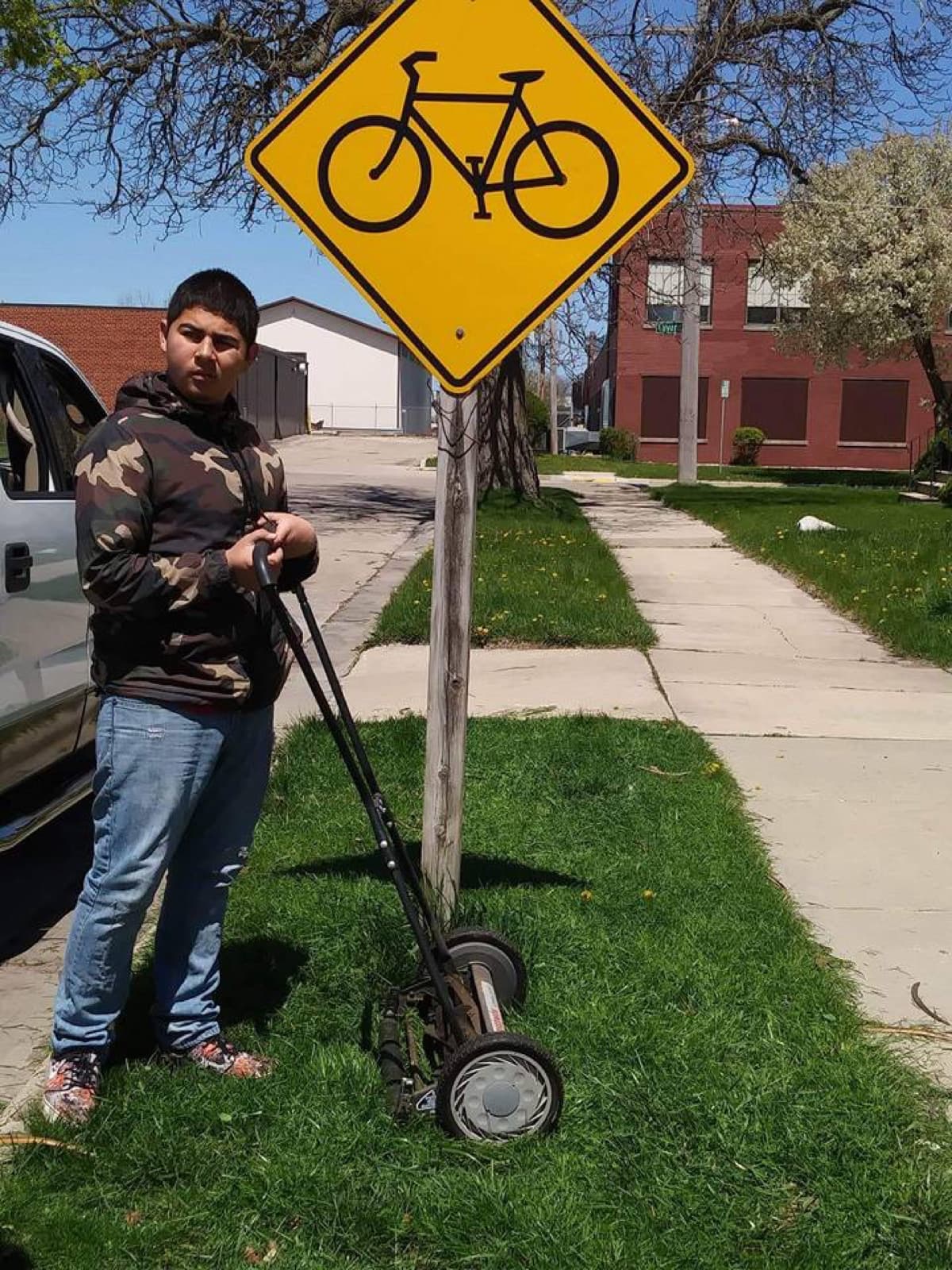 Teen with lawn mower ready to work